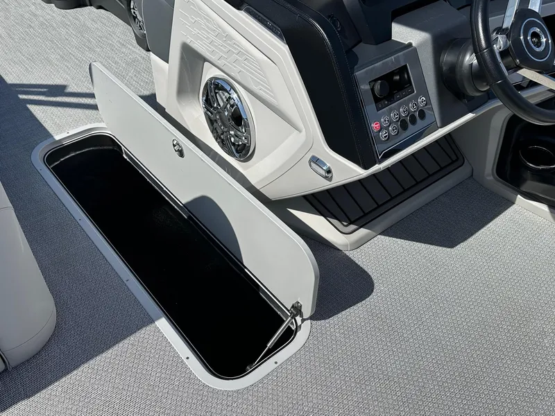 Slide: The Image of 2025 Avalon Catalina boat interior with open storage compartment and control panel. - 19