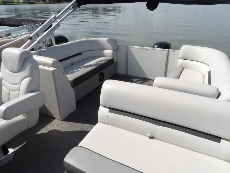 Slide: The Image of 2022 Sweetwater 2286 Tritoon interior with plush seating on calm water. - 3