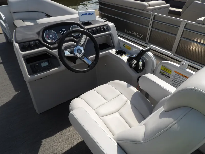 Slide: The Image of 2022 Sweetwater 2286 Tritoon boat cockpit with steering wheel and comfortable seating. - 5