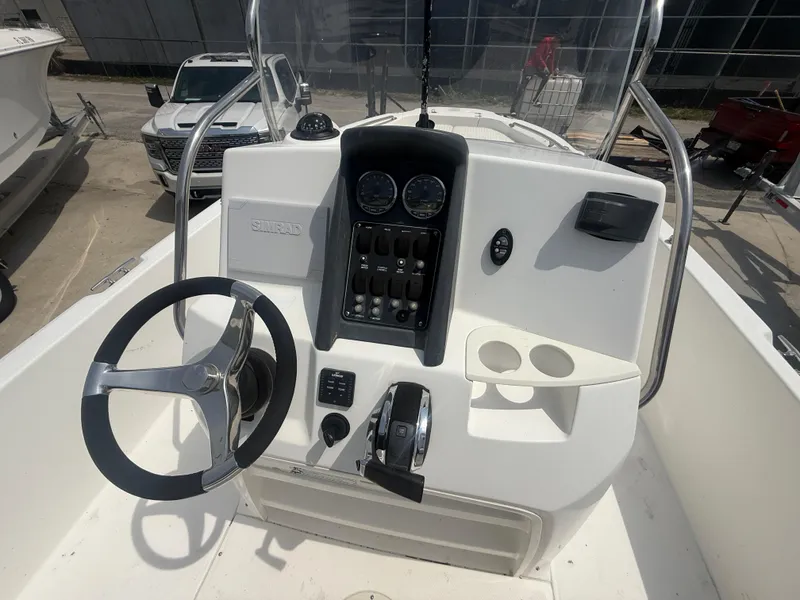 Slide: The Image of 2011 Boston Whaler 230 Dauntless boat console with steering wheel and control panel. - 17
