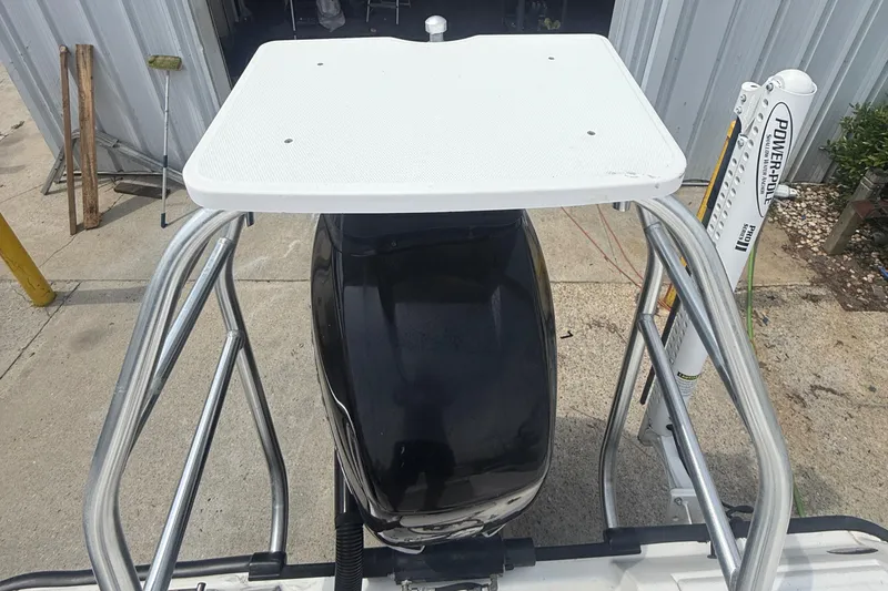 Slide: The Image of Boston Whaler 230 Dauntless 2011 boat engine with a white platform and metal rails. - 18