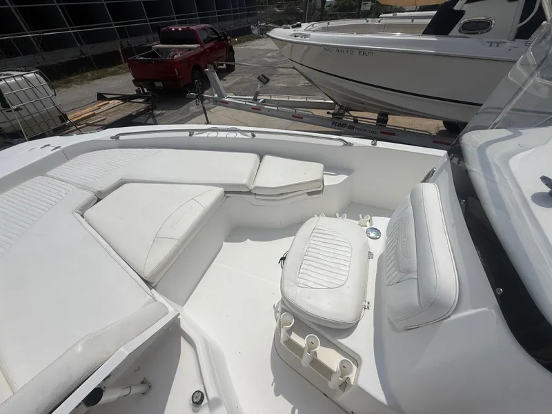 Slide: The Image of 2011 Boston Whaler 230 Dauntless boat interior with white seating and fishing rod holders. - 20