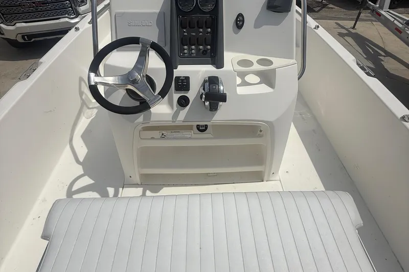 Slide: The Image of 2011 Boston Whaler 230 Dauntless boat console with steering wheel and controls. - 23