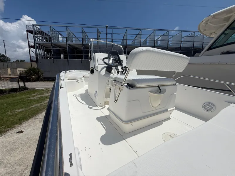 Slide: The Image of 2011 Boston Whaler 230 Dauntless boat interior with seating and steering console. - 24