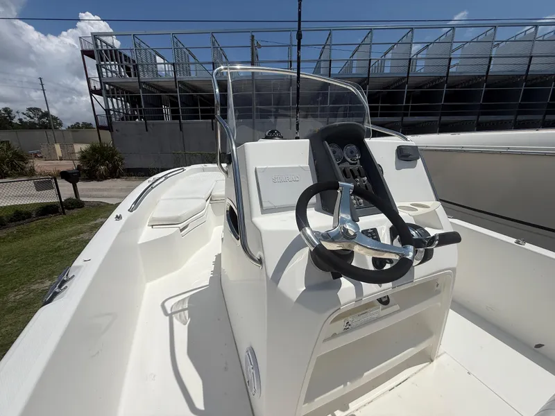Slide: The Image of 2011 Boston Whaler 230 Dauntless boat interior with steering wheel and console. - 25