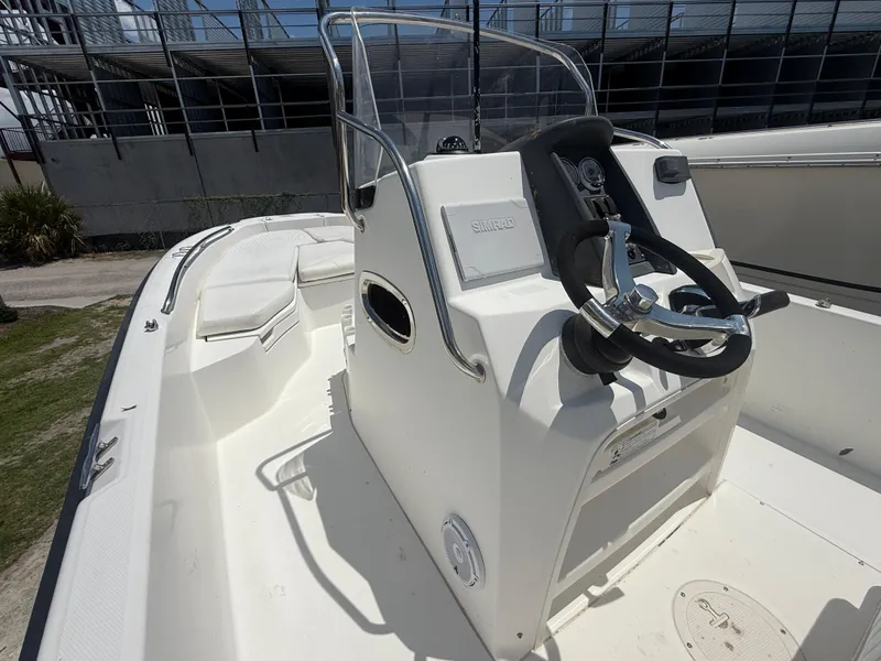 Slide: The Image of 2011 Boston Whaler 230 Dauntless boat interior with steering console and seating. - 26