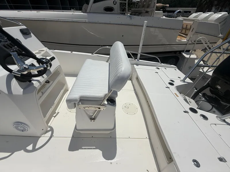 Slide: The Image of 2011 Boston Whaler 230 Dauntless boat interior with steering wheel and seating. - 27