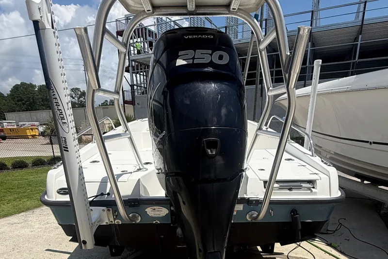 Slide: The Image of 2011 Boston Whaler 230 Dauntless boat with a 250 Verado engine, docked outdoors. - 28