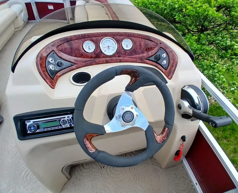 Slide: The Image of 2013 Sun Tracker Party Barge 22 DLX steering console with gauges and controls. - 3