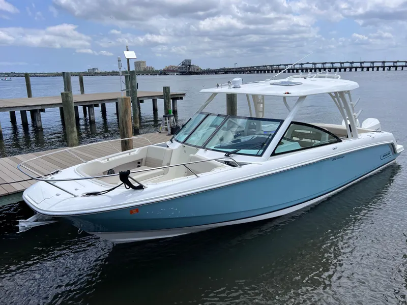 Slide: The Image of 2022 Boston Whaler 320 Vantage boat docked, light blue hull, joystick control, 154 hours. - 11