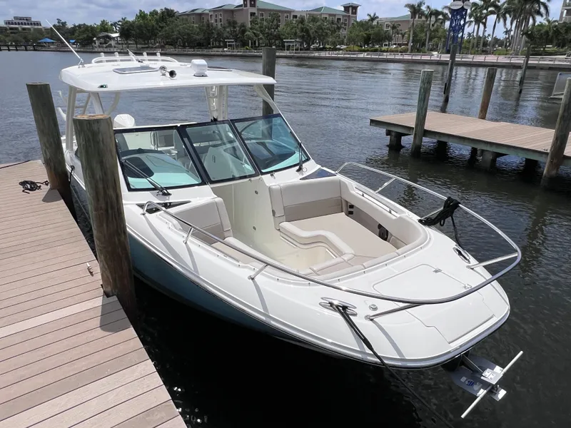 Slide: The Image of 2022 Boston Whaler 320 Vantage boat docked, featuring joystick control and spacious seating. - 15