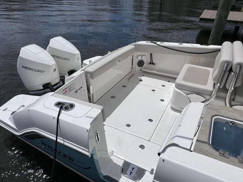 Slide: The Image of 2022 Boston Whaler 320 Vantage boat with dual Mercury engines, spacious deck, and joystick control. - 17