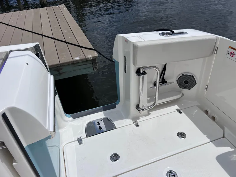 Slide: The Image of 2022 Boston Whaler 320 Vantage boat deck near dock, featuring joystick control. - 18