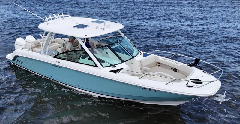 Slide: The Image of 2022 Boston Whaler 320 Vantage boat on water, featuring joystick control. - 2