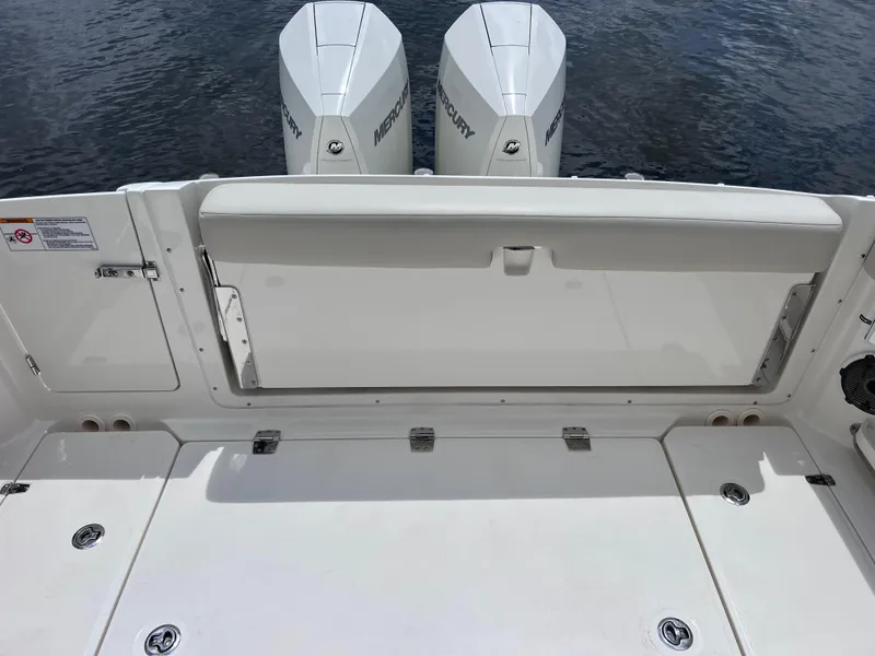 Slide: The Image of 2022 Boston Whaler 320 Vantage boat deck with twin Mercury engines. - 20