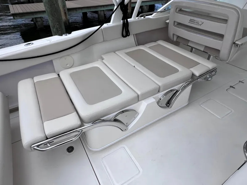 Slide: The Image of 2022 Boston Whaler 320 Vantage boat seating area with cushioned seats and sleek design. - 26