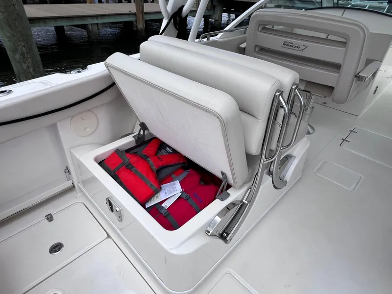 Slide: The Image of 2022 Boston Whaler 320 Vantage boat seat storage with life jackets. - 29