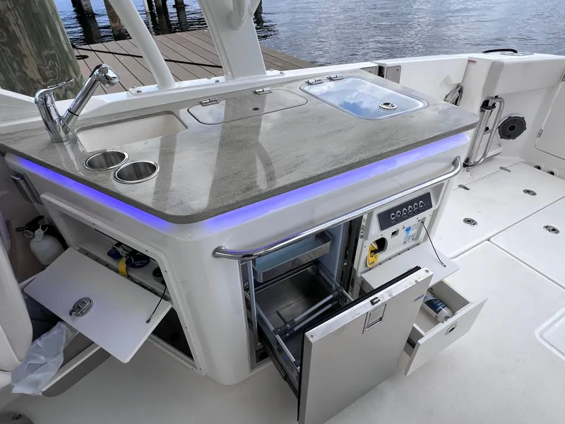Slide: The Image of 2022 Boston Whaler 320 Vantage boat with sleek outdoor kitchen and modern amenities. - 34