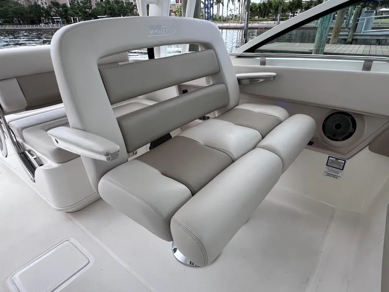 Slide: The Image of 2022 Boston Whaler 320 Vantage boat interior seating, featuring comfortable gray upholstery. - 39