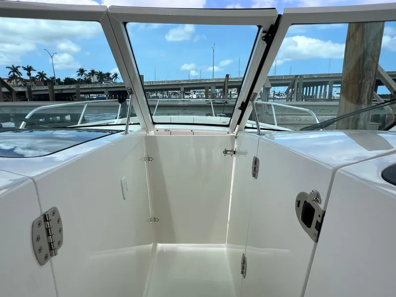 Slide: The Image of 2022 Boston Whaler 320 Vantage boat interior with open deck and clear sky background. - 46