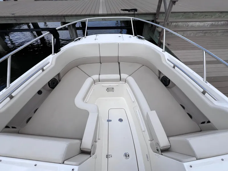 Slide: The Image of 2022 Boston Whaler 320 Vantage boat interior with white seating and deck view. - 48