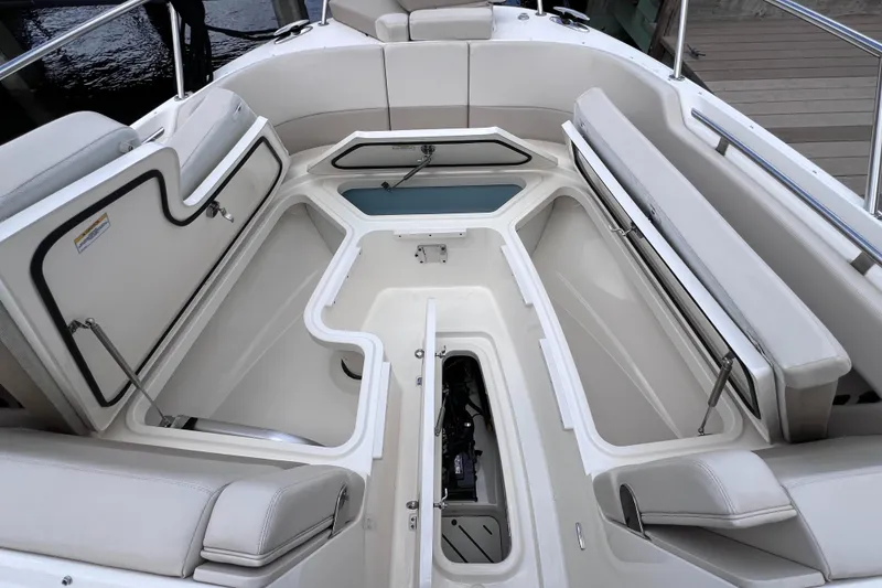 Slide: The Image of 2022 Boston Whaler 320 Vantage boat interior with seating and storage compartments. - 49