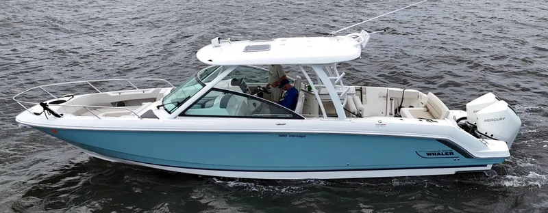 Slide: The Image of 2022 Boston Whaler 320 Vantage boat on water, blue hull, joystick control, 154 hours. - 5