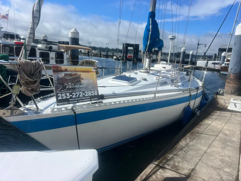 Slide: The Image of 1985 Wauquiez Pretorian Sloop docked at marina under clear blue sky. - 2