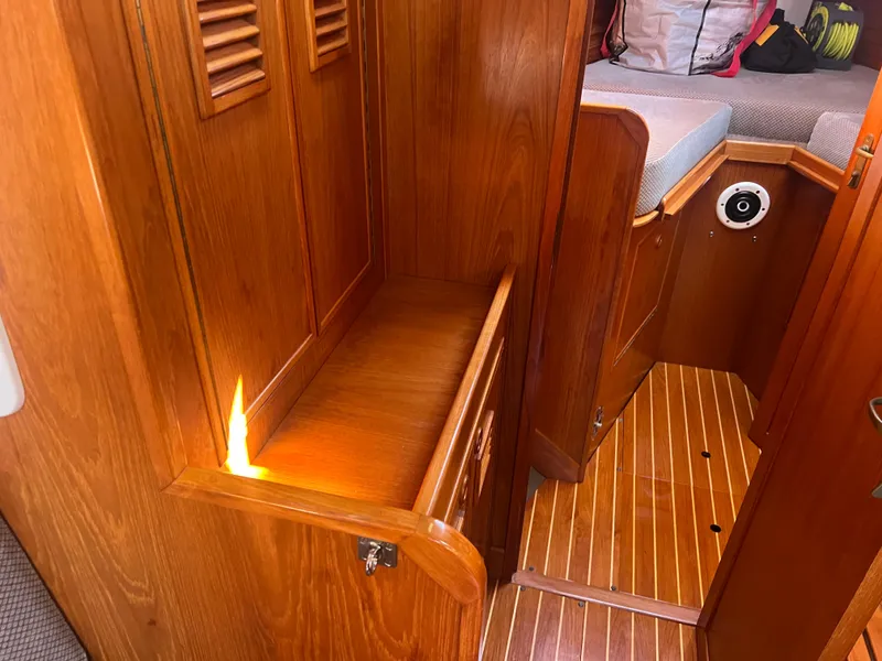 Slide: The Image of Interior of 1985 Wauquiez Pretorian Sloop with wooden cabinetry and flooring. - 30