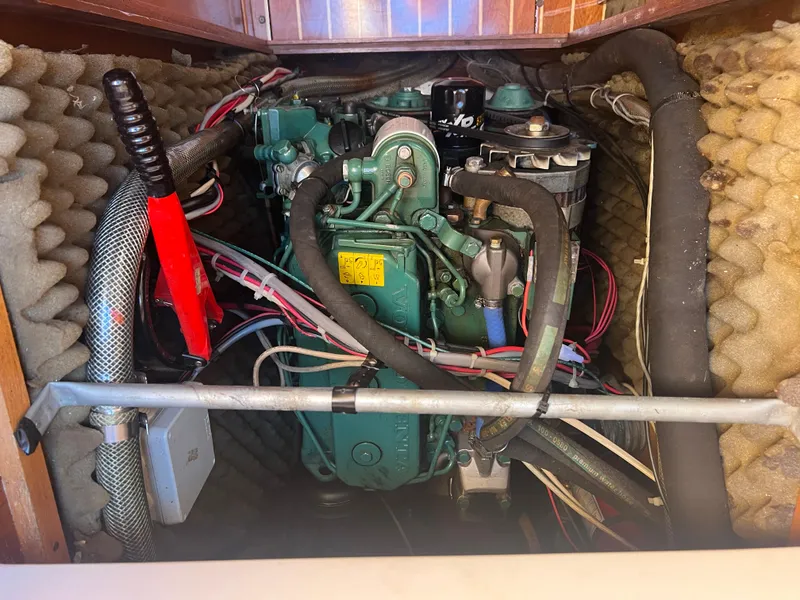 Slide: The Image of Engine compartment of a 1985 Wauquiez Pretorian Sloop, featuring a well-maintained marine engine. - 32