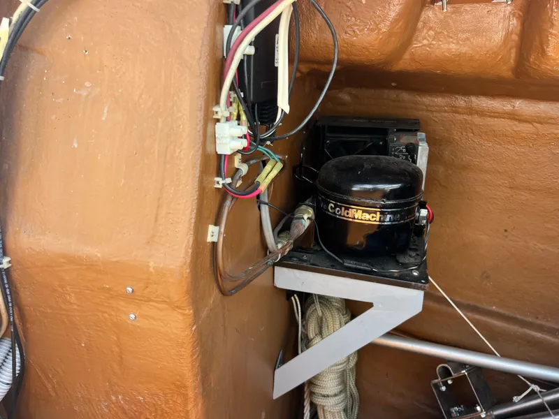 Slide: The Image of Electrical components inside 1985 Wauquiez Pretorien Sloop, featuring ColdMachine compressor. - 34