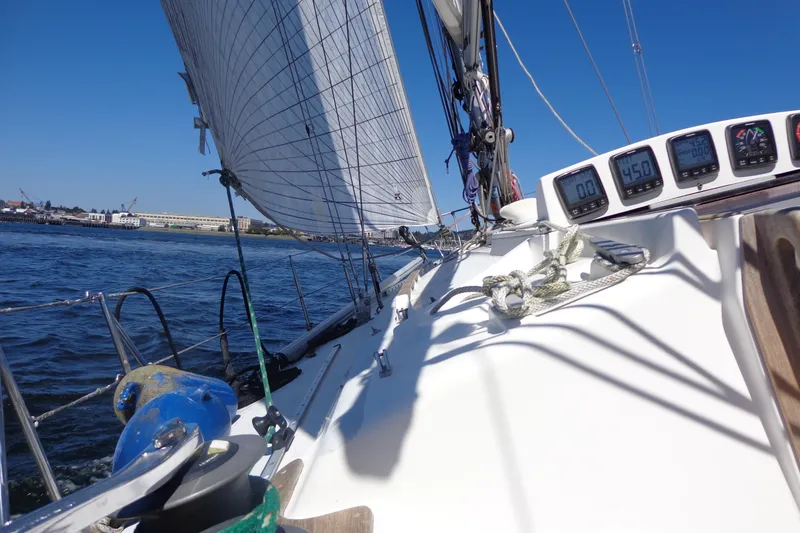Slide: The Image of Sailing on a 1985 Wauquiez Pretorien Masthead yacht with clear blue skies. - 40