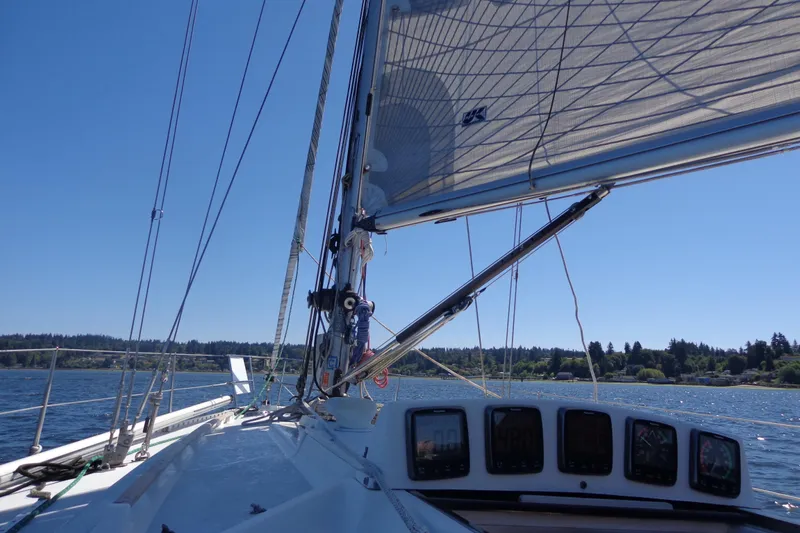 Slide: The Image of Sailing on a 1985 Wauquiez Pretorien Masthead under clear blue skies. - 41