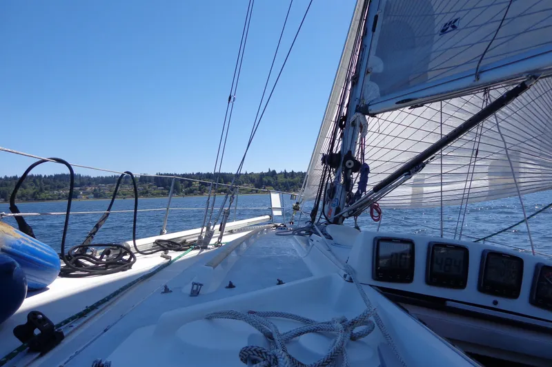 Slide: The Image of Sailing on a 1985 Wauquiez Pretorien Masthead yacht, clear blue skies, and calm waters. - 44