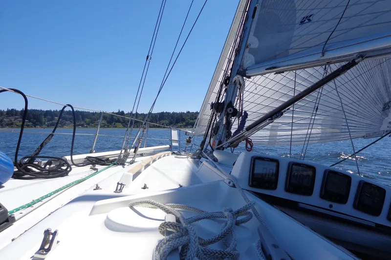 Slide: The Image of 1985 Wauquiez Pretorien Masthead sailboat on a sunny day, sailing on calm waters. - 45