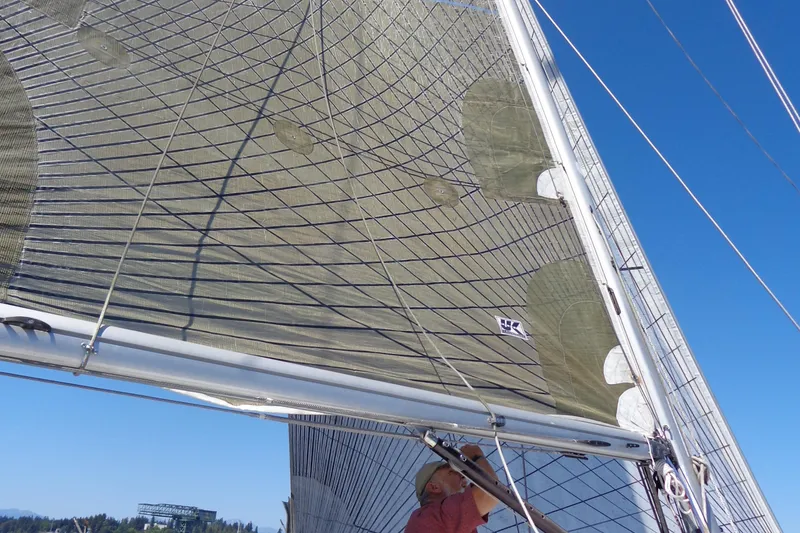 Slide: The Image of Sail of 1985 Wauquiez Pretorien Masthead yacht against clear blue sky. - 46
