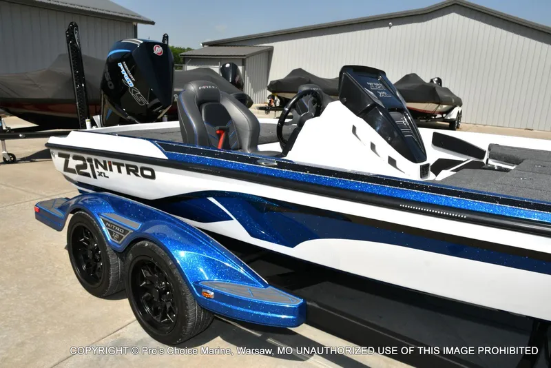Slide: The Image of 2023 Nitro Z21 XL Pro boat with blue accents on a trailer. - 18