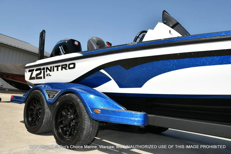 Slide: The Image of 2023 Nitro Z21 XL Pro boat with blue accents on a trailer. - 19
