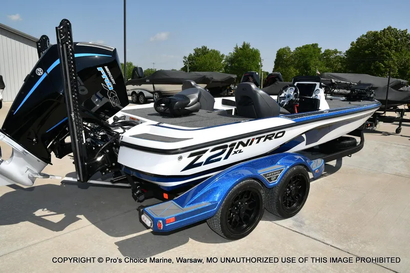 Slide: The Image of 2023 Nitro Z21 XL Pro boat with trailer, displayed outdoors on a sunny day. - 21