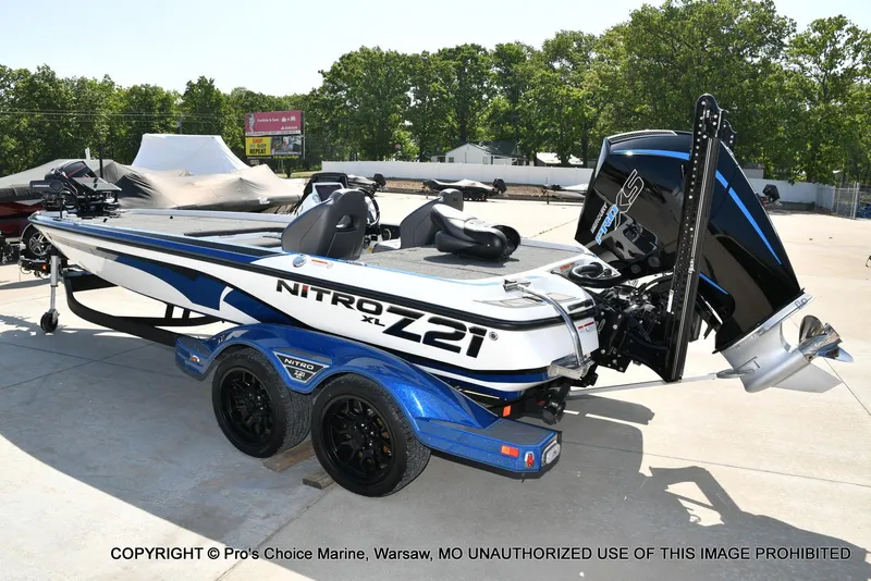 Slide: The Image of 2023 Nitro Z21 XL Pro boat with sleek design, parked outdoors on a sunny day. - 28