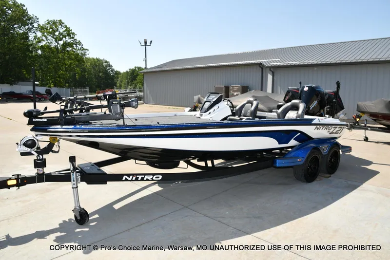 Slide: The Image of 2023 Nitro Z21 XL Pro boat on trailer, parked outdoors near a building. - 30