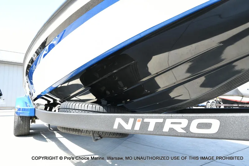 Slide: The Image of 2023 Nitro Z21 XL Pro boat on trailer, close-up view of hull and logo. - 34