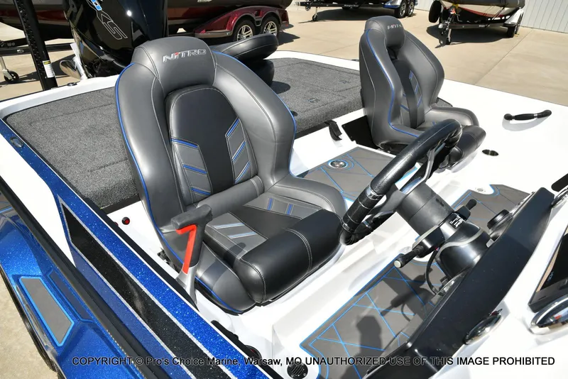 Slide: The Image of 2023 Nitro Z21 XL Pro boat interior with sleek seats and modern steering wheel design. - 38