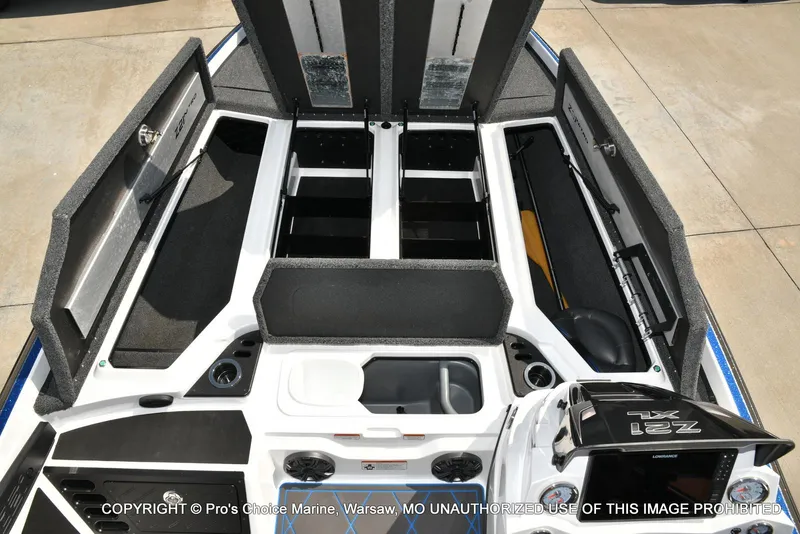 Slide: The Image of 2023 Nitro Z21 XL Pro boat interior with open storage compartments and control panel. - 9