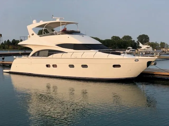 The Image of 2004 Marquis 59 yacht docked in a serene marina setting. - 0