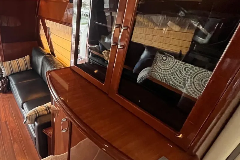 Slide: The Image of Luxurious interior of a 2004 Marquis 59 yacht with elegant wood cabinetry and plush seating. - 10