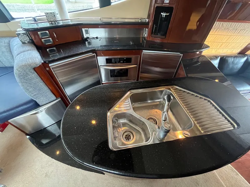 Slide: The Image of Luxurious kitchen area in a 2004 Marquis 59 yacht with modern appliances and sleek design. - 11