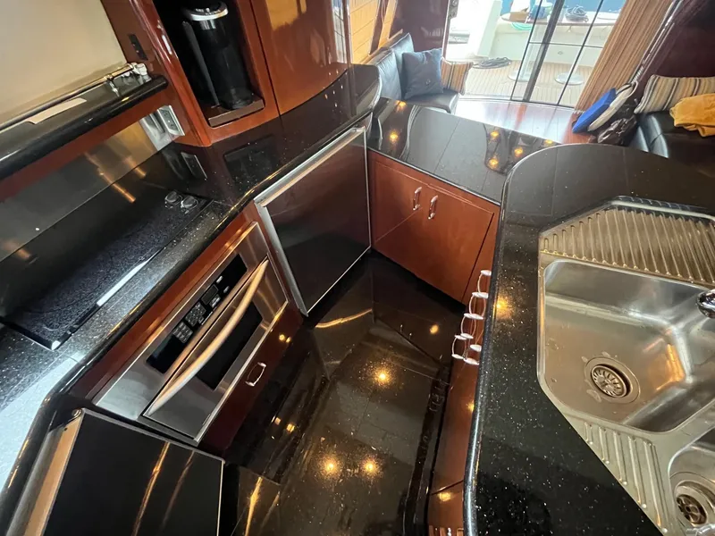 Slide: The Image of Luxurious kitchen interior of a 2004 Marquis 59 yacht with sleek countertops and modern appliances. - 12