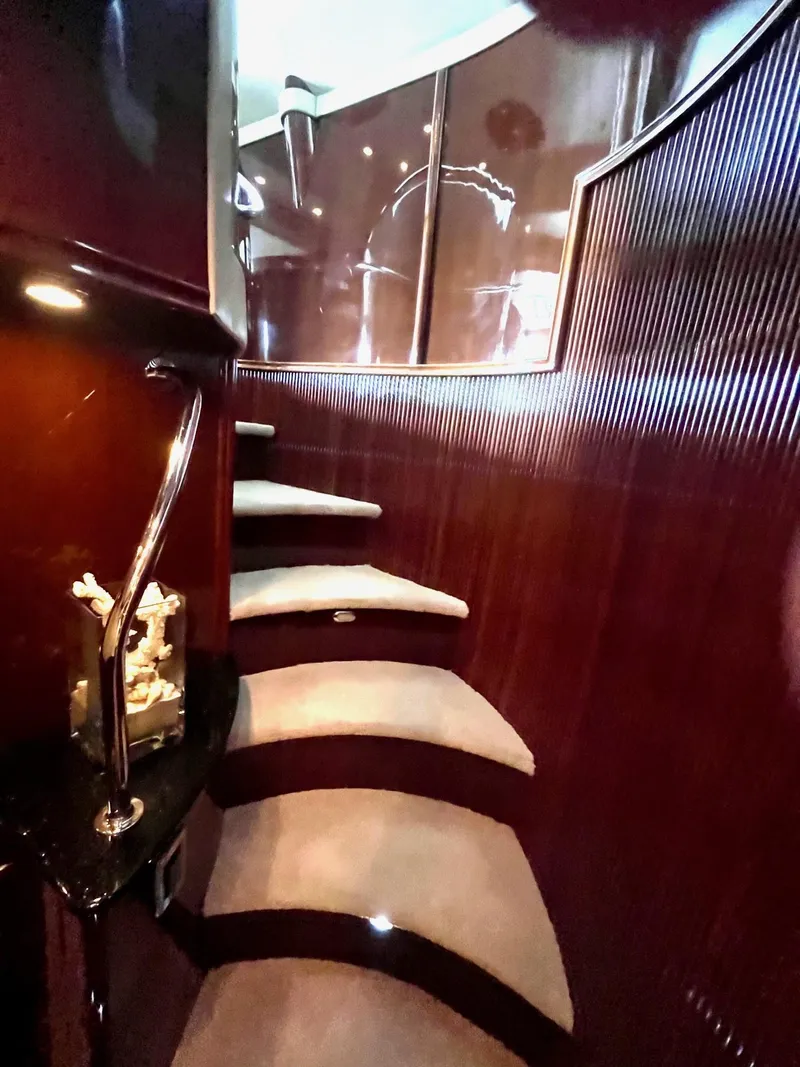 Slide: The Image of Luxurious interior staircase of a 2004 Marquis 59 yacht with elegant wood paneling. - 13