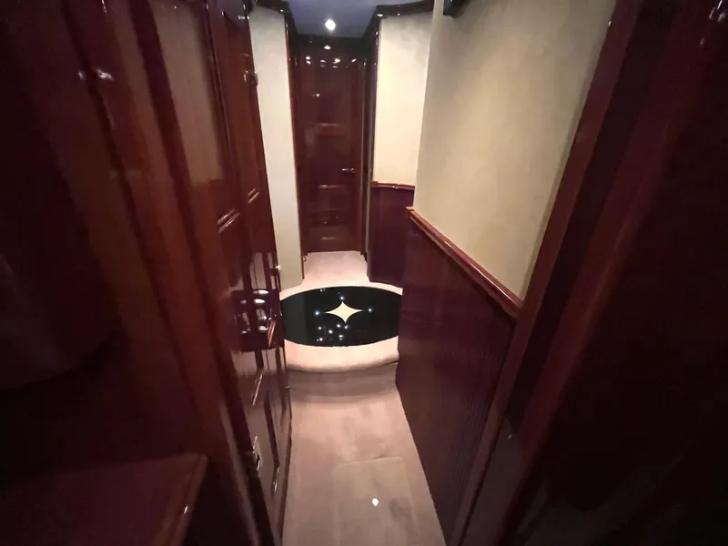 Slide: The Image of Luxurious hallway interior of a 2004 Marquis 59 yacht with polished wood finishes. - 14